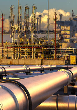 Metal pipeline supplying a boat in the background_AdobeStock